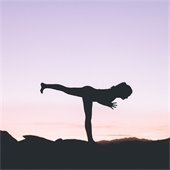 woman doing yoga at sunset 