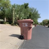 Trash can against curb