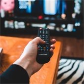 Someone pointing a remote control at a tv