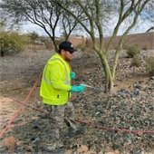 DLC employee spraying pre-emergent