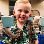 child with snake around neck