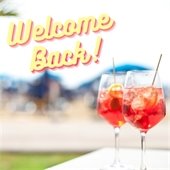 two pink cocktails and welcome back in cursive