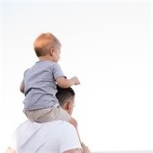 father with son on his shoulders
