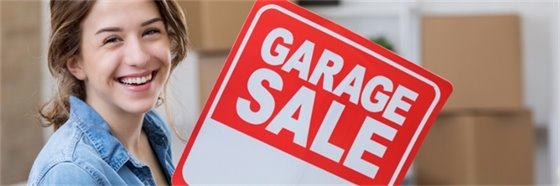 girl holding garage sale sign