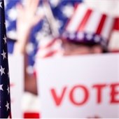 flag and "vote" sign