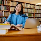 girl sitting in a library studying