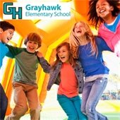 kids jumping on a bounce house with a grayhawk elementary logo