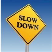 yellow sign that reads "slow down"