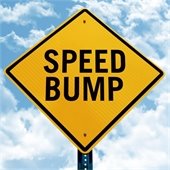 yellow road sign for speed bumps